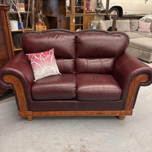 Oxblood Red Rolled Arm Leather Love Seat w Brass Nail Trim & Carved Wood Detail