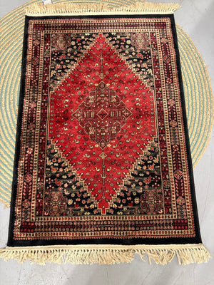 Traditional Red & Black Pakistani Wool Blend Area Rug Featuring Central Medallion and Fringed Ends